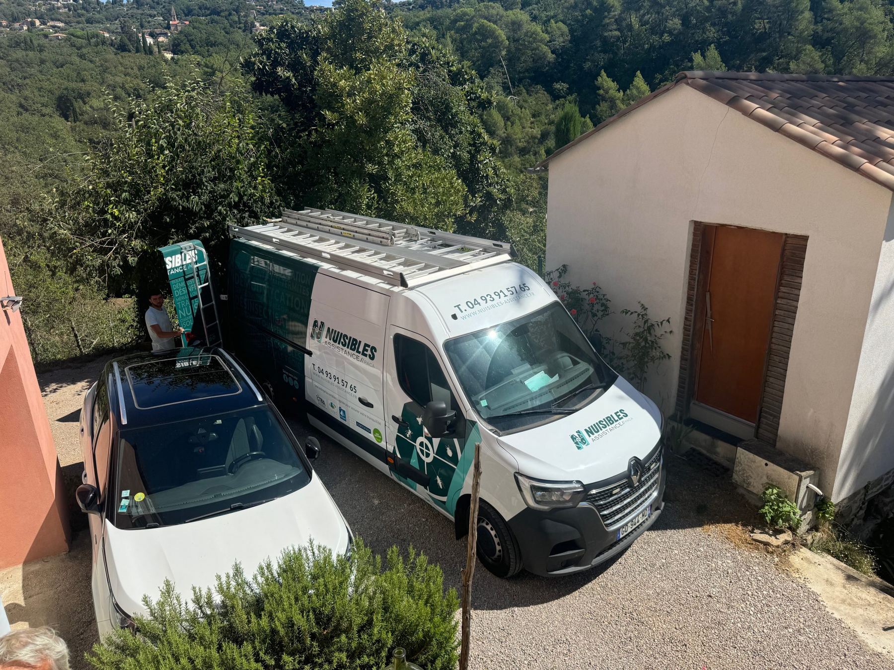 Le fourgon de Nuisibles Assistance garé devant une maison, dans les collines